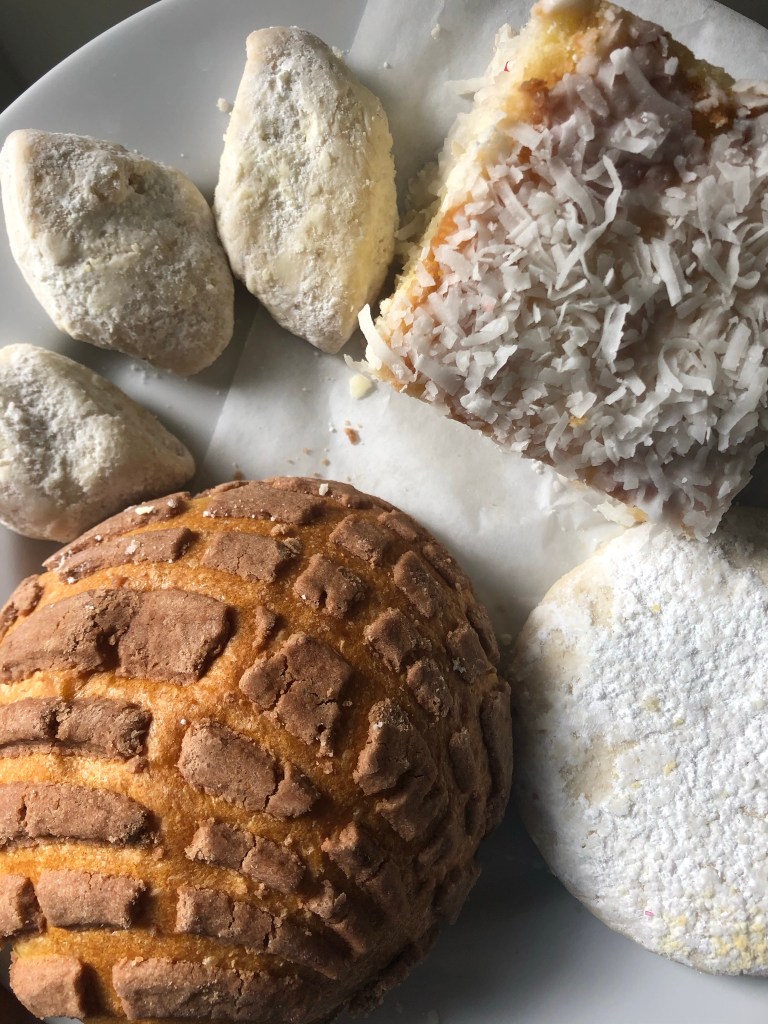 Chocolate-covered conchas, polvorones, and Charleston coconut cake from Lopez Bakery and Restaurant